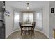 Cozy dining area with table, chairs and natural light from windows with sheer white curtains at 1032 Cadbury Ct., Conway, SC 29527