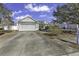 Charming home with a gray two-car garage and driveway, complemented by lovely curb appeal at 1032 Cadbury Ct., Conway, SC 29527