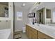 Modern bathroom with a large vanity, soaking tub and walk-in shower with a mounted television at 1032 Cadbury Ct., Conway, SC 29527