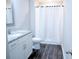 Bathroom featuring white vanity with granite countertop, white cabinets, mirror and tub with curtain at 106 Berkman Ct., Conway, SC 29527