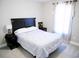 Cozy bedroom with a neatly made bed and an elegant dark wood headboard, enhanced by natural light from the window at 106 Berkman Ct., Conway, SC 29527