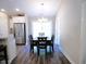 Dining room featuring modern table, chairs, chandelier, and view into kitchen with stainless appliances at 106 Berkman Ct., Conway, SC 29527