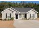 Charming single-story home with gray siding, black shutters, and a well-manicured lawn and driveway at 106 Berkman Ct., Conway, SC 29527