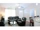 Inviting living room with sleek leather furniture, fan and vaulted ceiling, and open access to dining area at 106 Berkman Ct., Conway, SC 29527