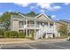 Charming tan two-story condo with white railings, green roof, and well-manicured landscaping at 1081 Blue Stem Dr. # 35-B, Pawleys Island, SC 29585