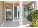 Inviting covered front porch features a glass front door and charming green shutters, enhancing curb appeal at 1081 Blue Stem Dr. # 35-B, Pawleys Island, SC 29585