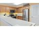 This kitchen features wooden cabinets, stainless steel appliances, and a sink built into the countertop at 1081 Blue Stem Dr. # 35-B, Pawleys Island, SC 29585