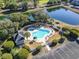 Aerial view showcasing a community pool, hot tub, lush landscaping, and convenient parking area at 1081 Blue Stem Dr. # 35-B, Pawleys Island, SC 29585