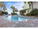 Relaxing pool area with blue tile and lush surrounding greenery and lounge chairs at 1105 S Ocean Blvd. # 1004, Myrtle Beach, SC 29577