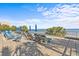 Spacious pool deck area featuring numerous lounge chairs, umbrellas, and views of the ocean and beach at 1105 S Ocean Blvd. # 1004, Myrtle Beach, SC 29577