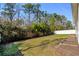 Green backyard featuring a privacy fence and bordered by trees and shrubs at 1108 Inlet View Dr., North Myrtle Beach, SC 29582