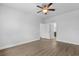 Bedroom with wood-look floors, ceiling fan, and double doors leading to the Primary bathroom at 1108 Inlet View Dr., North Myrtle Beach, SC 29582