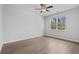 Bright bedroom with ceiling fan, large window, and wood-look floors, offers a relaxing retreat at 1108 Inlet View Dr., North Myrtle Beach, SC 29582