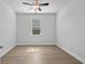 Bright bedroom featuring a ceiling fan, wood-look flooring, and a window at 1108 Inlet View Dr., North Myrtle Beach, SC 29582