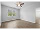 Bedroom featuring a large window, ceiling fan, and wood-look flooring, creating a comfortable atmosphere at 1108 Inlet View Dr., North Myrtle Beach, SC 29582