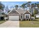 Charming single-story home with stone accents, manicured lawn, and an attached two-car garage at 1108 Inlet View Dr., North Myrtle Beach, SC 29582