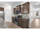 Kitchen featuring dark wood cabinets, stainless steel appliances, granite counters, and wood-look tile floors at 1108 Inlet View Dr., North Myrtle Beach, SC 29582