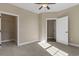 Spacious carpeted bedroom featuring a ceiling fan, closet, and an adjoining bathroom at 117 Ella Kinley Circle # 201, Myrtle Beach, SC 29588