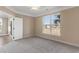 Cozy bedroom featuring plush carpeting, a ceiling fan, and a large window offering neighborhood views at 117 Ella Kinley Circle # 201, Myrtle Beach, SC 29588