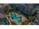 Overhead view of an inviting community pool area with palm trees and outdoor seating near residential buildings at 117 Ella Kinley Circle # 201, Myrtle Beach, SC 29588