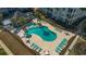 Community pool area with turquoise water, surrounded by palm trees, lounge chairs and tables at 117 Ella Kinley Circle # 201, Myrtle Beach, SC 29588