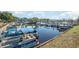 Scenic boat dock with multiple boats and waterfront condos in the background on a sunny day at 1239 Cypress Shoal Dr., Conway, SC 29526