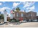 Charming building exterior with flags, clock tower, and well-maintained landscaping at 1239 Cypress Shoal Dr., Conway, SC 29526