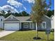 Charming single-story home featuring manicured lawn and a two-car garage, new construction at 1239 Cypress Shoal Dr., Conway, SC 29526