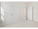 Bedroom featuring neutral carpet and large closet with bi-fold doors at 124 Old Chimney Ln, Conway, SC 29526