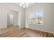 Bright dining room featuring wood floors, large windows, and an elegant light fixture at 124 Old Chimney Ln, Conway, SC 29526