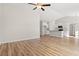 Open living room featuring hardwood floors, vaulted ceilings, and a view of the modern kitchen at 124 Old Chimney Ln, Conway, SC 29526