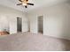 Spacious bedroom features tray ceiling, ceiling fan, and ensuite bathroom with walk-in closets at 124 Old Chimney Ln, Conway, SC 29526