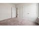 Bright bedroom featuring neutral walls, carpeted flooring, and white doors at 124 Old Chimney Ln, Conway, SC 29526