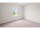 This bedroom offers a bright window and neutral carpeting at 124 Old Chimney Ln, Conway, SC 29526