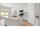 Open kitchen featuring a granite-topped island, stainless appliances, and stylish white cabinetry at 124 Old Chimney Ln, Conway, SC 29526