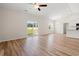 Bright living room featuring wood floors, a ceiling fan, and sliding glass doors to the backyard at 124 Old Chimney Ln, Conway, SC 29526