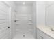 A bright bathroom with walk-in shower and a white vanity with chrome hardware at 1329 Palm Springs Paloma Dr, Longs, SC 29568