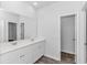 A bright bathroom with double sinks, white cabinets, large mirror, and wood-look flooring at 1329 Palm Springs Paloma Dr, Longs, SC 29568