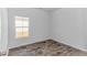 Bedroom with wood-look flooring, one window, neutral paint, and a white door at 1329 Palm Springs Paloma Dr, Longs, SC 29568