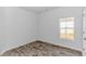 Bedroom with wood-look flooring, one window, neutral paint, and a white door at 1329 Palm Springs Paloma Dr, Longs, SC 29568