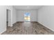 Bright and airy living room featuring wood-look flooring and natural light from sliding glass doors at 1329 Palm Springs Paloma Dr, Longs, SC 29568