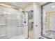 Modern bathroom with a glass shower, neutral colors, and a decorative framed mirror at 1417 S Ocean Blvd. # 202, Surfside Beach, SC 29575