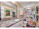 Nicely decorated bathroom with granite countertop, large mirror, and colorful shower curtain at 1417 S Ocean Blvd. # 202, Surfside Beach, SC 29575