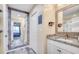 This neutral bathroom features a granite countertop, framed mirrors and an open view to the bedroom at 1417 S Ocean Blvd. # 202, Surfside Beach, SC 29575