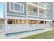 Home exterior with rectangular pool, fences, and the building with balconies in the background at 1417 S Ocean Blvd. # 202, Surfside Beach, SC 29575