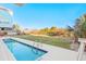 Outdoor view of the pool with ladder, green yard, plants, and building in the background at 1417 S Ocean Blvd. # 202, Surfside Beach, SC 29575