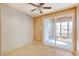 Bedroom with ceiling fan and glass sliding doors to sunroom at 1424 Glenns Bay Rd. # 1424, Myrtle Beach, SC 29575