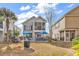 Backyard with a well-manicured lawn, a hot tub, and a screened-in porch at 1424 Powhaton Dr., Myrtle Beach, SC 29577