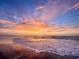 Picturesque beach sunset with vibrant colors reflecting on the wet sand and gentle waves at 1424 Powhaton Dr., Myrtle Beach, SC 29577