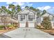 Charming two-story home features a spacious driveway and attached two-car garage at 1424 Powhaton Dr., Myrtle Beach, SC 29577